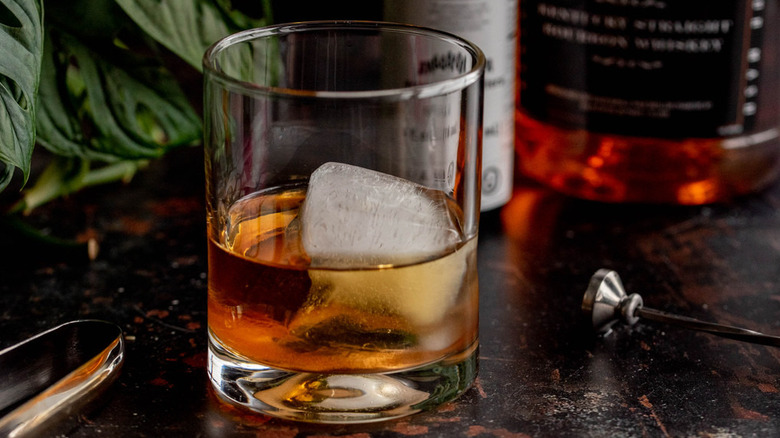 bourbon and ice cube in glass