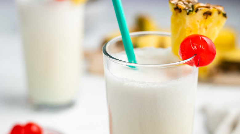 piña colada in glass with straw