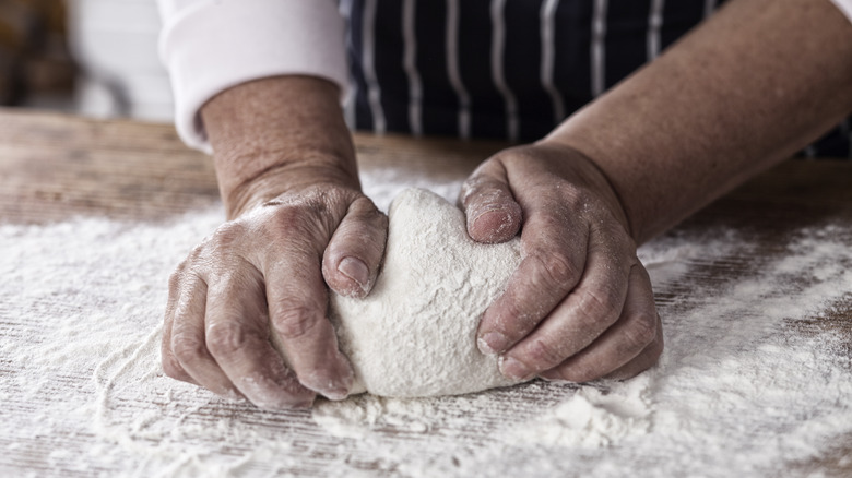 hands kneading dough