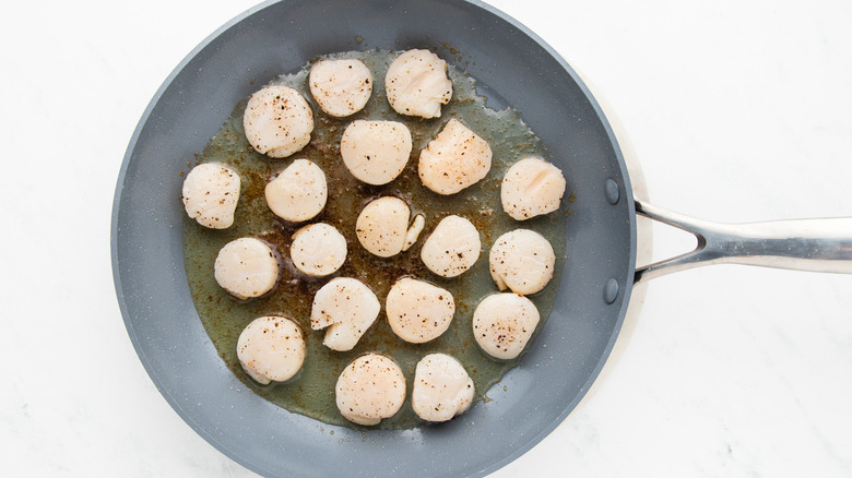 scallops frying in pan