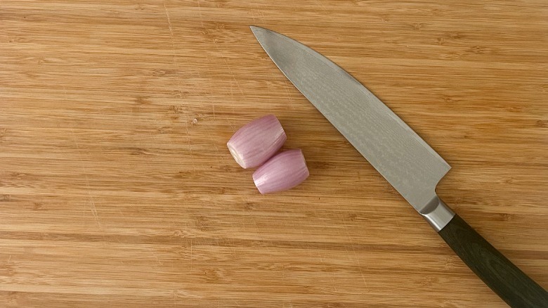 shallots and knife on cutting board