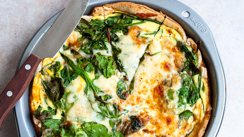 spinach quiche with knife