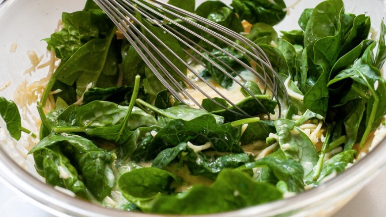 spinach and whisk in bowl