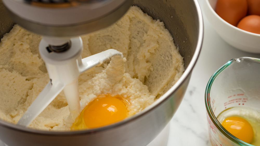 adding eggs to classic vanilla cake recipe