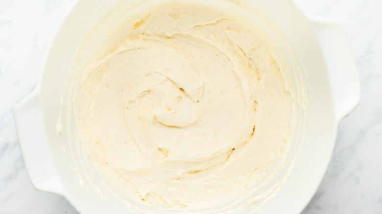 vanilla frosting in white bowl