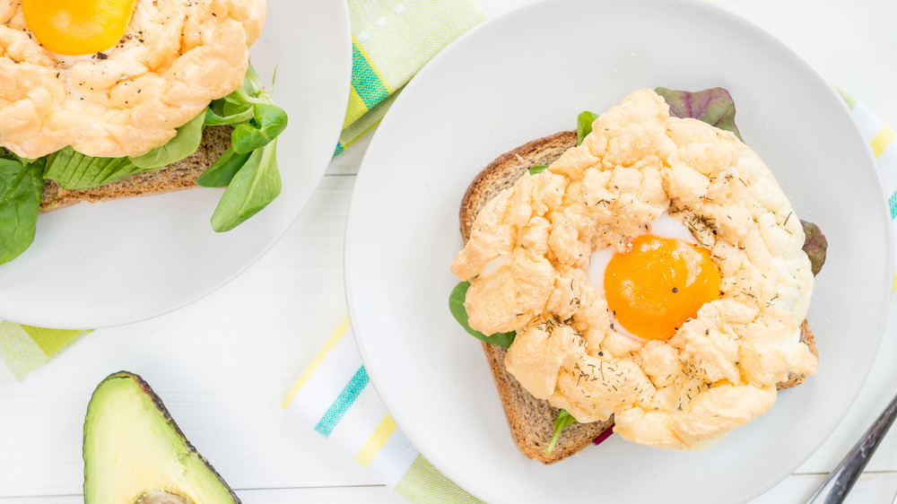 Cloud eggs on toast with colorful background and avocado