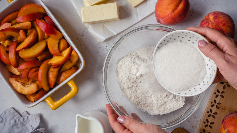 person making peach cobbler