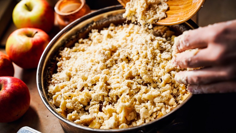 sprinkling topping on apple crisp