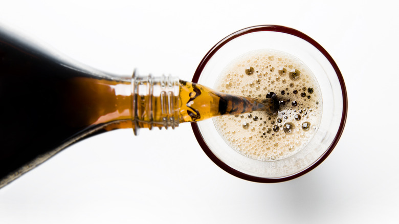 pouring cola into glass