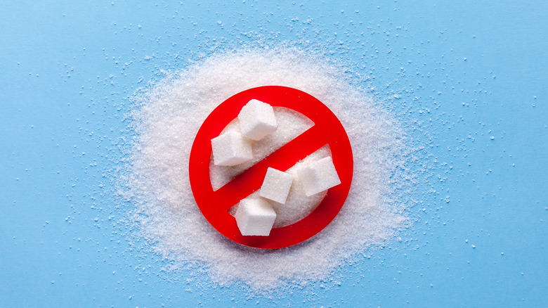 Sugar in crossed-out sign on blue background