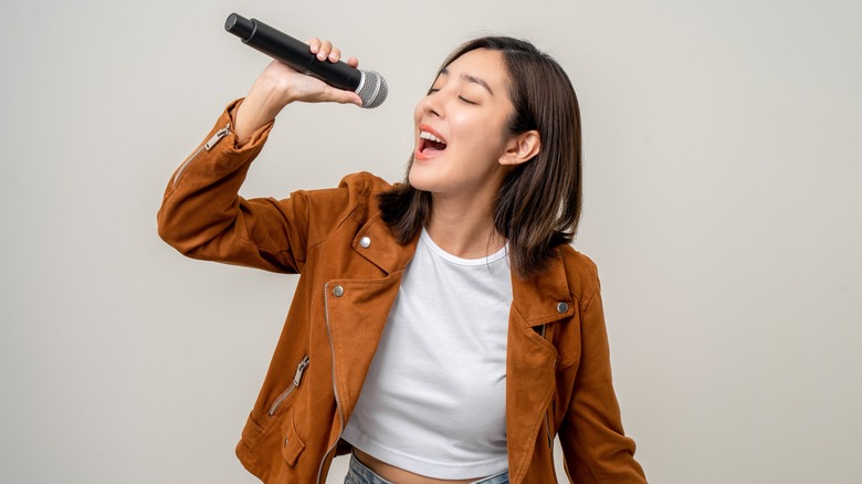 woman singing with microphone