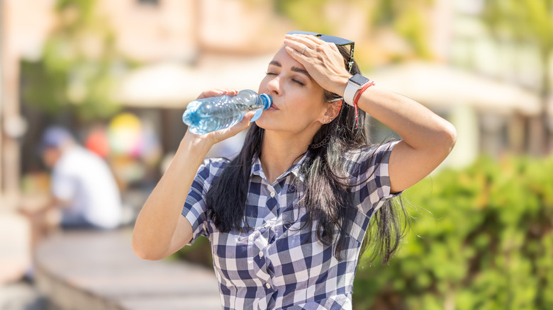 woman hydrating on sunny day