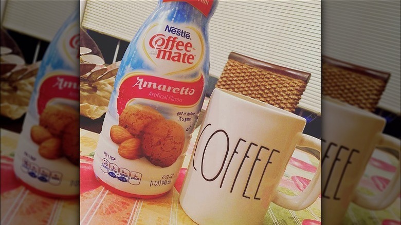 Coffee Mate Amaretto creamer bottle and coffee mug