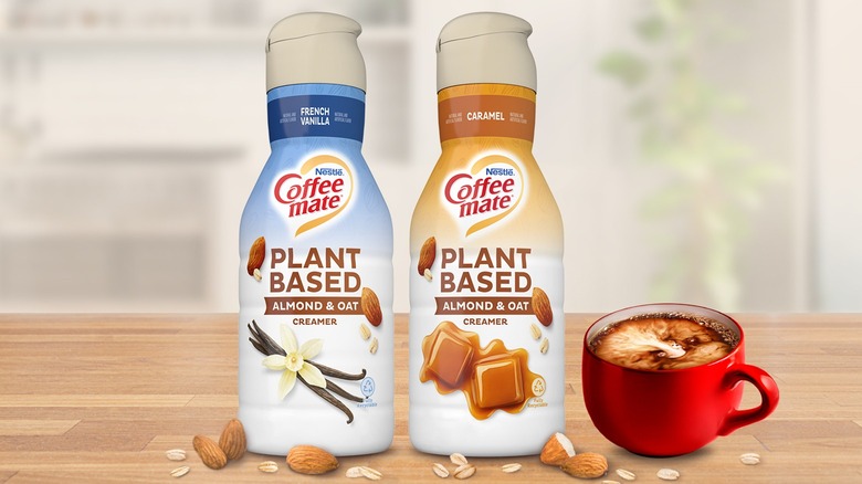 two bottles of Coffee Mate plant-based coffee creamers