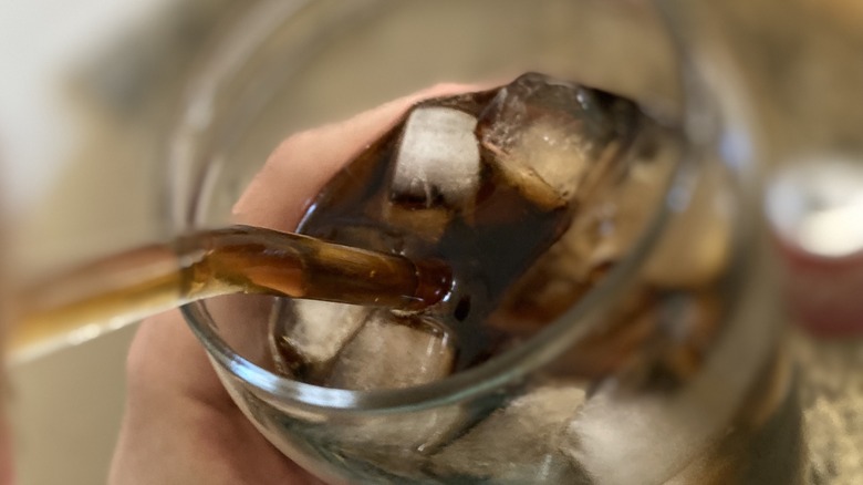 Person sipping Coke Spiced through straw