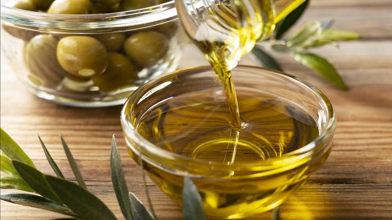 Drizzling olive oil into a bowl