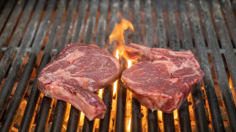 Steak over grill flames