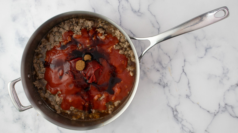 Cooked ground beef with sauces in skillet