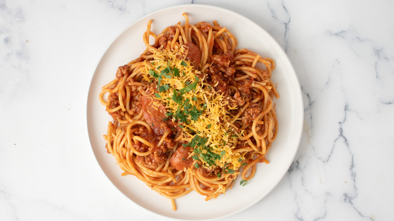 Plate of filipino spaghetti with hot dogs and pork