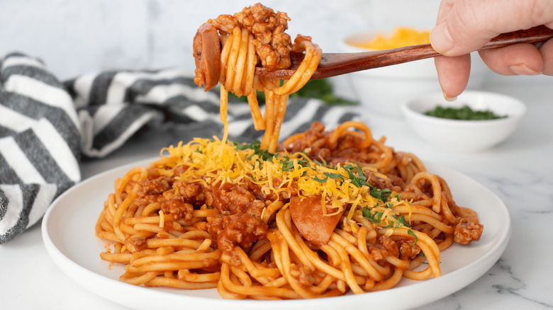 Plate of Filipino spaghetti with hot dogs and pork