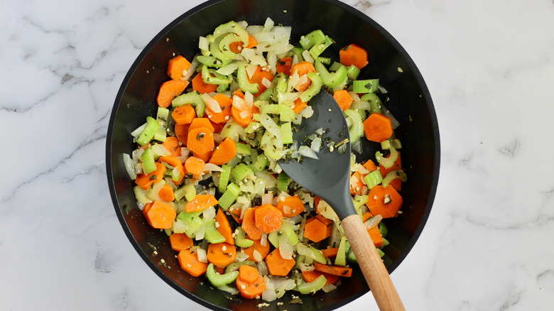 vegetables added to black skillet