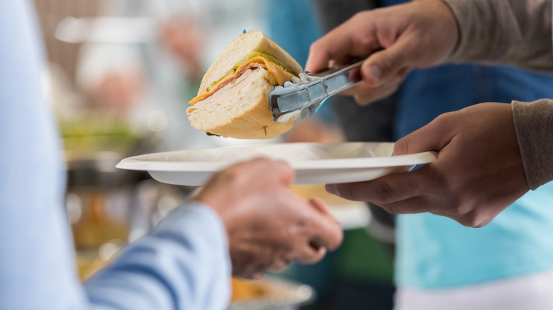 putting sandwich on paper plates