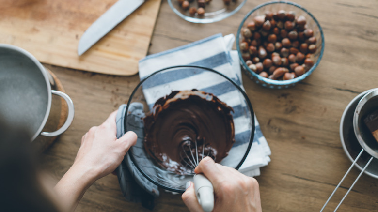 person whisking chocolate