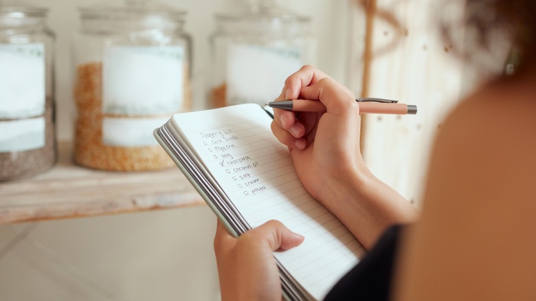 woman making shopping list