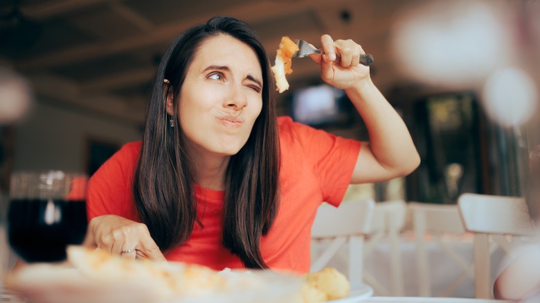 woman inspecting food closely