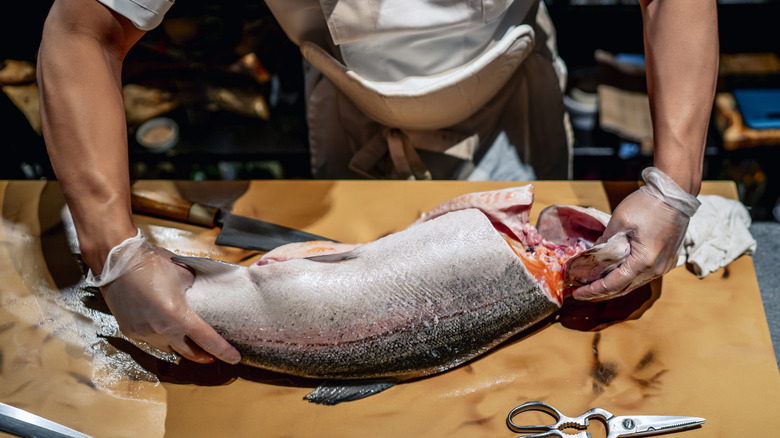 person gutting a fish