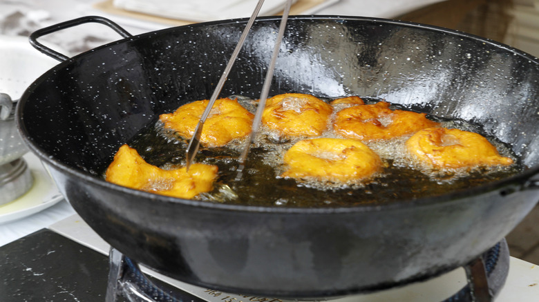 person frying in wok