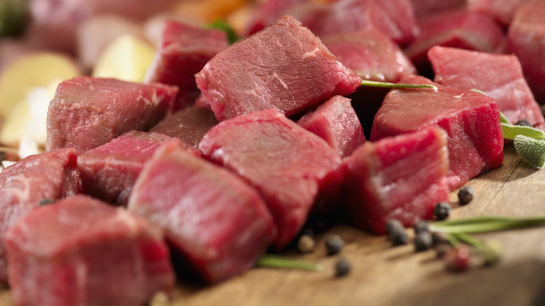 Beef stew meat on cutting board