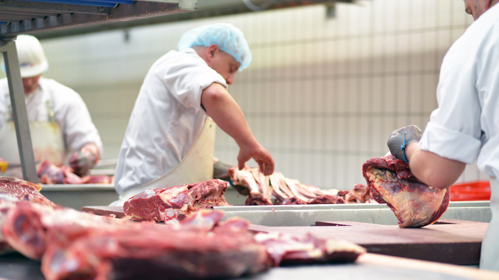 Butchers cutting up meat