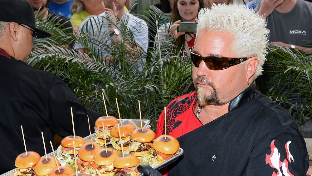 Guy Fieri serving burgers