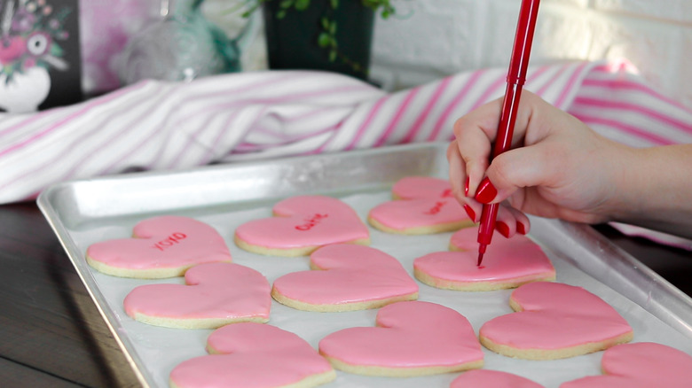 conversation heart cookies being decorated