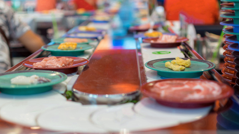 colored plates at a revolving sushi restaurant