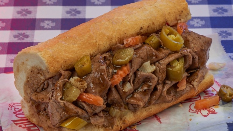 Close up of Portillo's Italian Beef sandwich on a blue checkered tablecloth