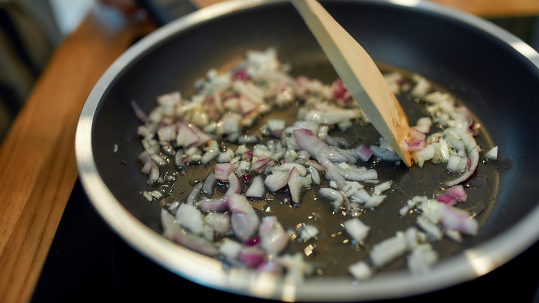 onions sautéing in a pan