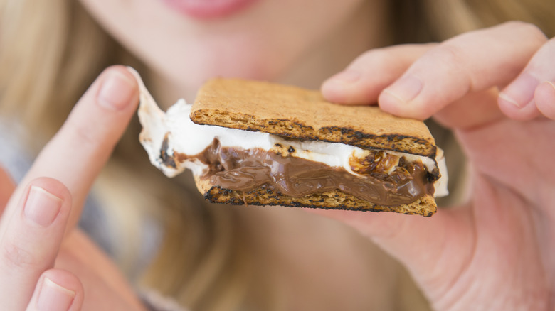 hands holding gooey s'mores