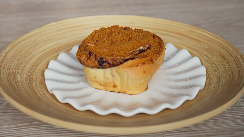 cookie butter cinnamon roll on a wooden plate