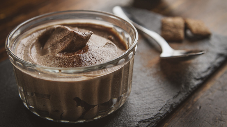 chocolate mousse in small jar on a wooden table