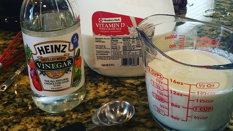 Carton of milk, bottle of vinegar, measuring cup