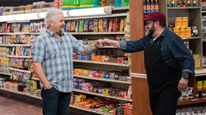 Guy Fieri fist bumps Carl Ruiz on Guy's Grocery Games