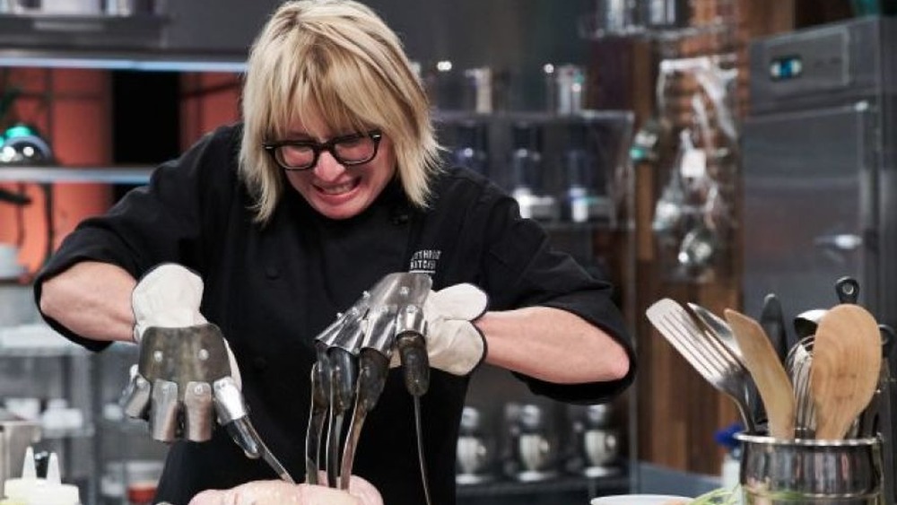 Screenshot of chef trying to cut meat with knife gloves