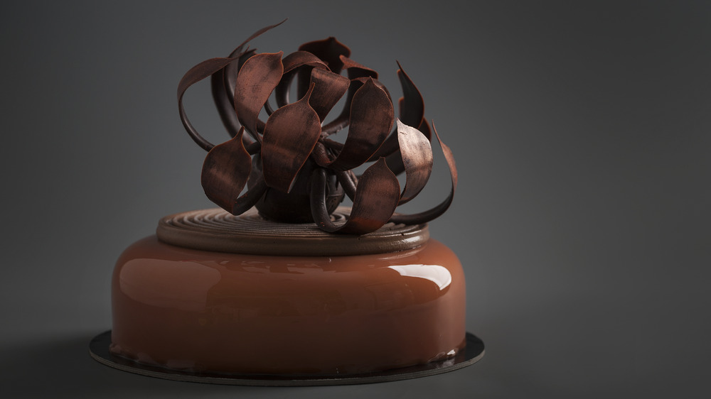 Chocolate cake topped with chocolate sculpture