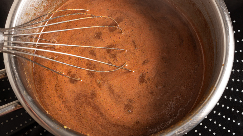 brown sauce in metal pot