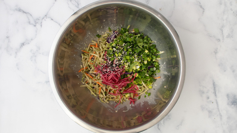 unmixed slaw ingredients in bowl