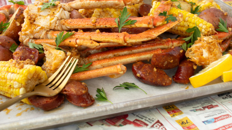 crab legs, potatoes, sausage, corn