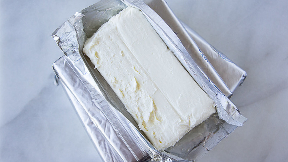 bricks of cream cheese, with one opened on top