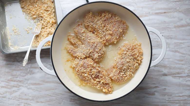 chicken frying in a pan